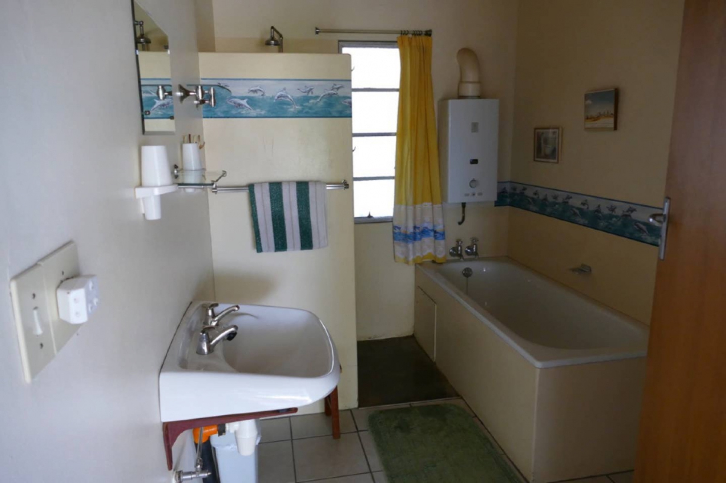 Bathroom with bath, basin and window