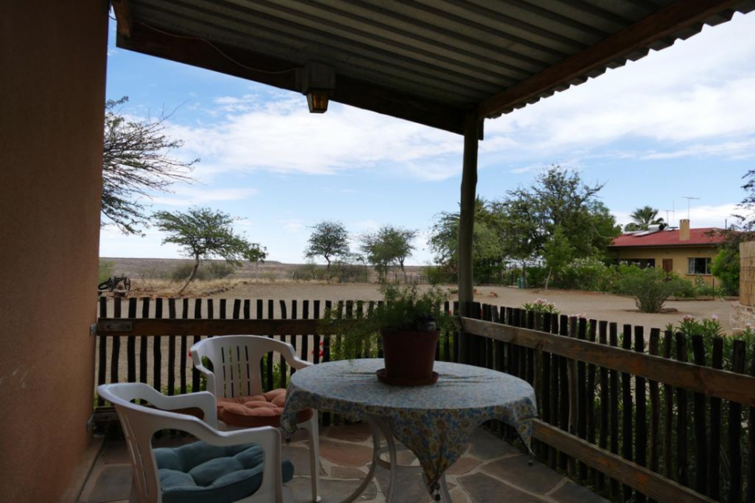 Shaded veranda with table and chairs