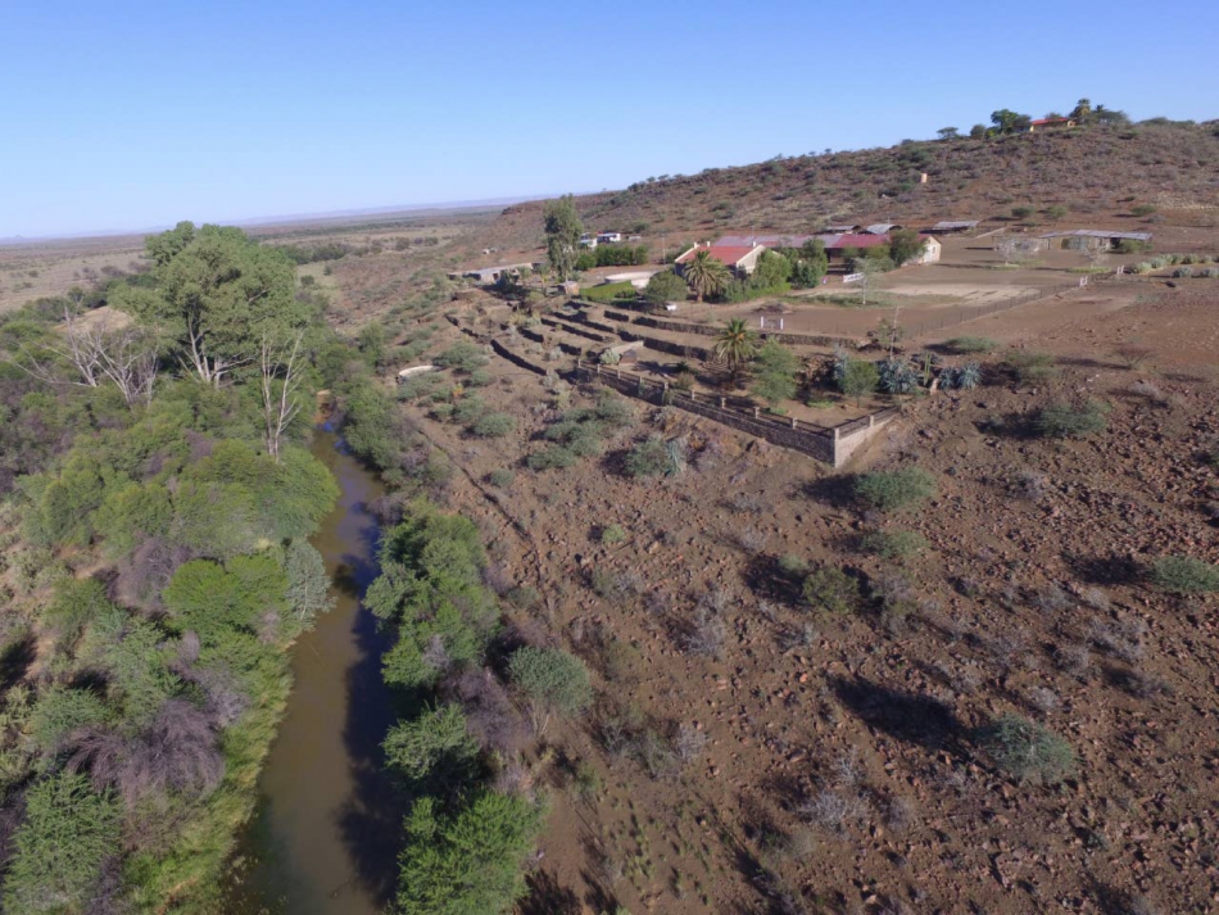 Aerial view over the dry riverbed and Gamis Farm landscape