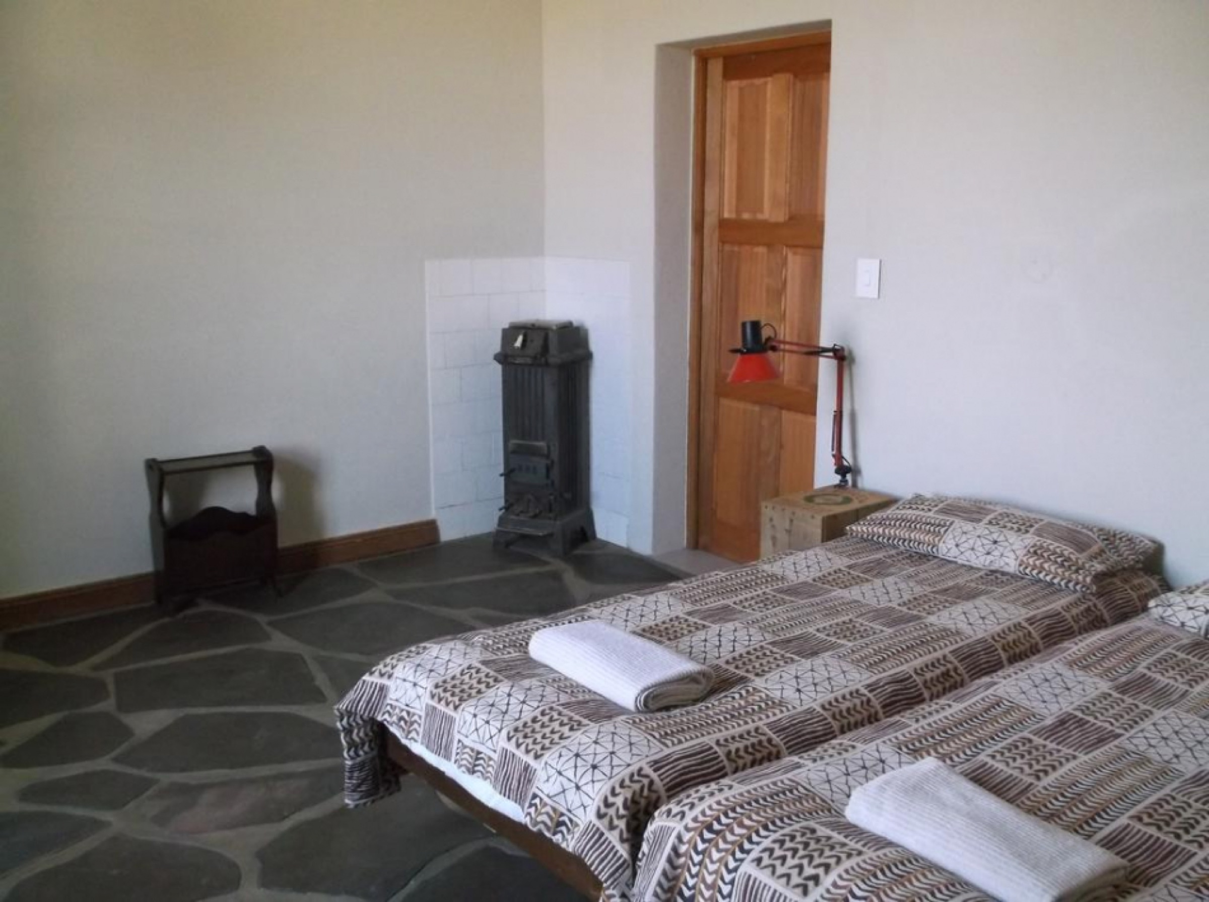 Bedroom with twin beds and small wood stove